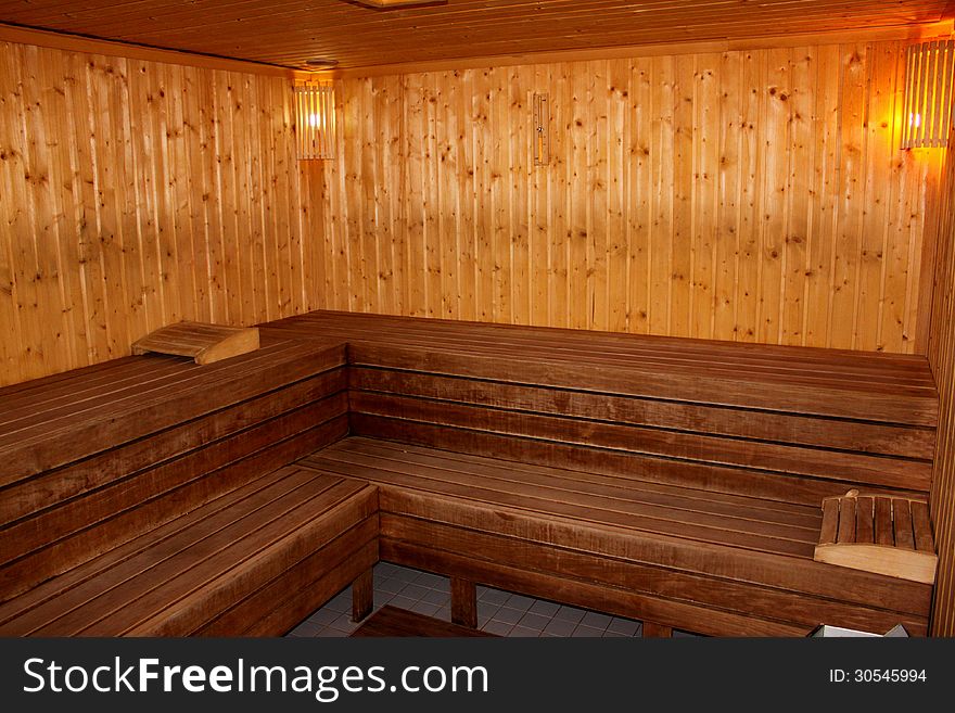 Finnish sauna interior lighted with wooden bench