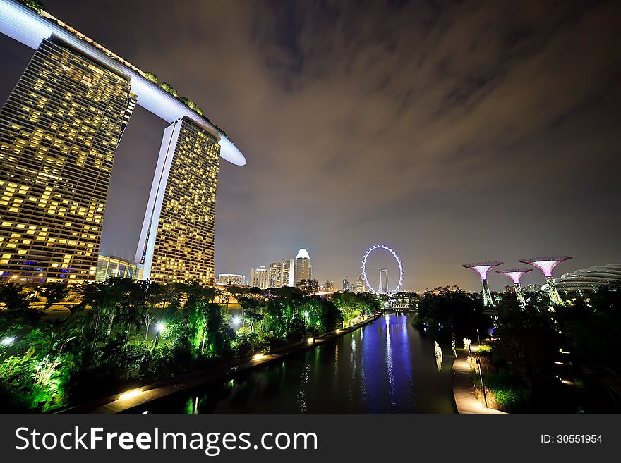 SINGAPORE - APRIL 14 : Nightscape of The Supertree at Gardens by the Bay, Marina Bay Sand and Singapore Flyer on April 14, 2013 Singapore. There are the main tourist attraction of Singapore City. SINGAPORE - APRIL 14 : Nightscape of The Supertree at Gardens by the Bay, Marina Bay Sand and Singapore Flyer on April 14, 2013 Singapore. There are the main tourist attraction of Singapore City.