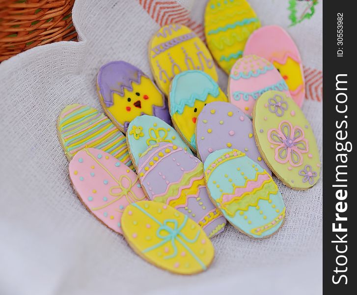 In basket on linen towel cookies in the form of Easter eggs