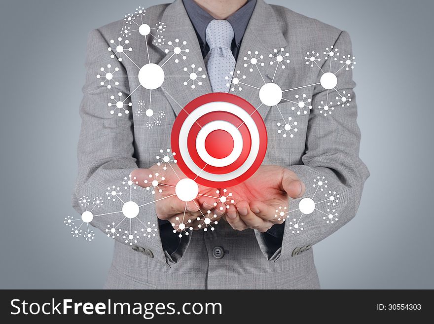 Businessman hand shows target symbol as concept