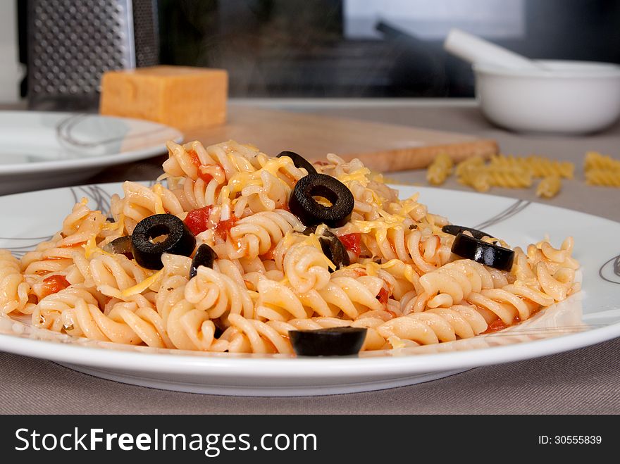 Pasta with tomatos, garlic and black olives. Pasta with tomatos, garlic and black olives