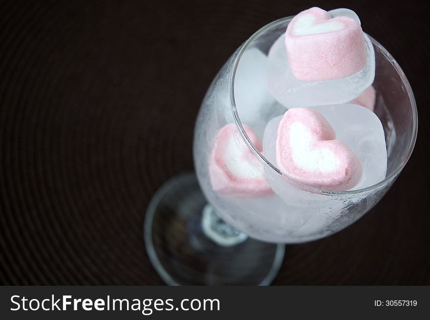 Pink marshmallow frozen in ice cube. Pink marshmallow frozen in ice cube