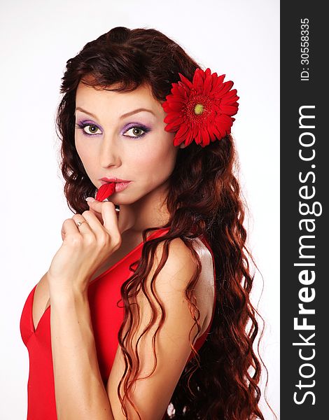 The girl in a red dress with red gerberas. The girl in a red dress with red gerberas