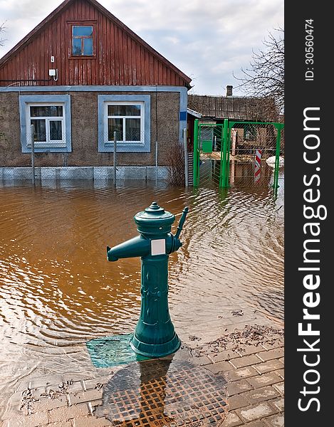 Flooding of urban river drowned house and street hydrant