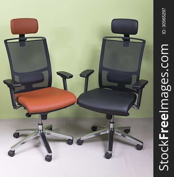 High-end office chairs covered with red and black leather. High-end office chairs covered with red and black leather