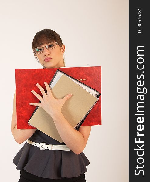 Young attractive female office worker taking notes