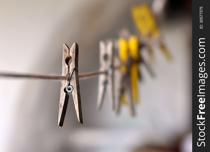 Wooden pegs on a rope and a blurry background