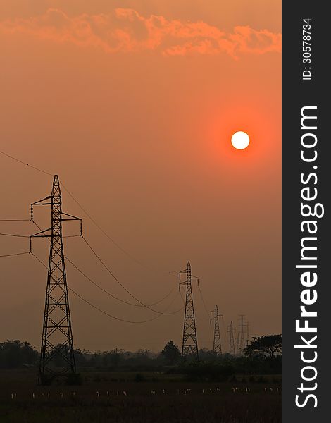 Electricity Pillars against a colorful yellow sunset
