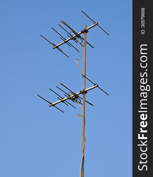 Hight receiver antenna in sunlight and blue sky. Hight receiver antenna in sunlight and blue sky