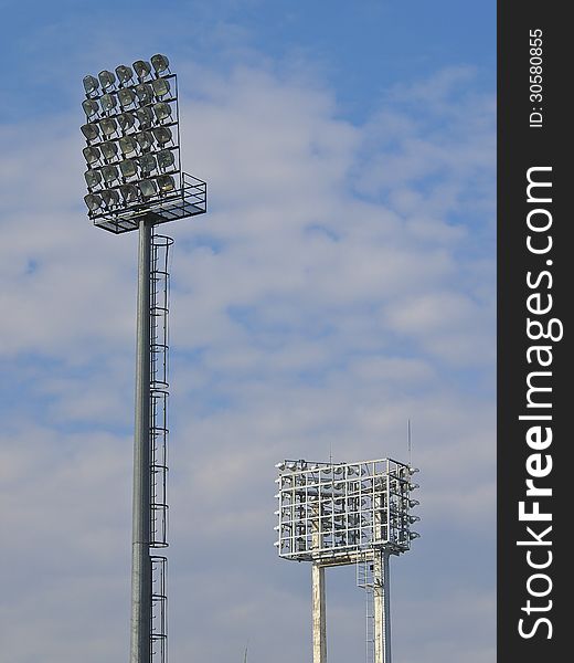 Pair of football stadium floodlight in cloudy day