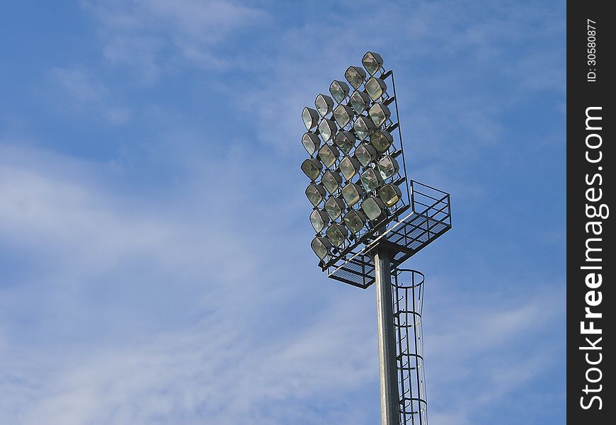 Football stadium floodlight in blue sky and white cloud. Football stadium floodlight in blue sky and white cloud