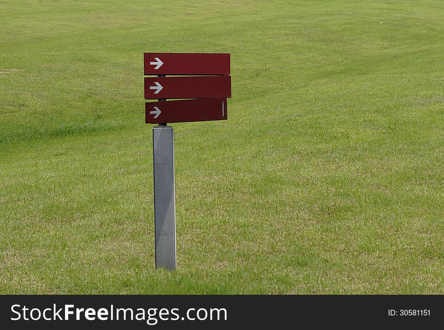 Blank sign with arrow in grassland. Blank sign with arrow in grassland