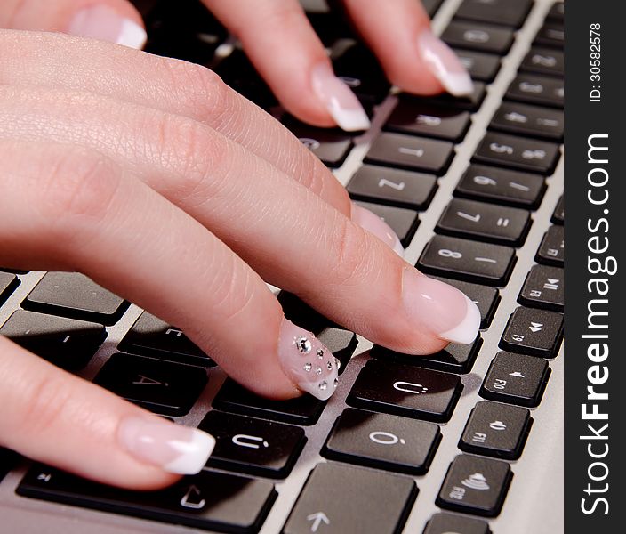 Woman is typing on a laptop