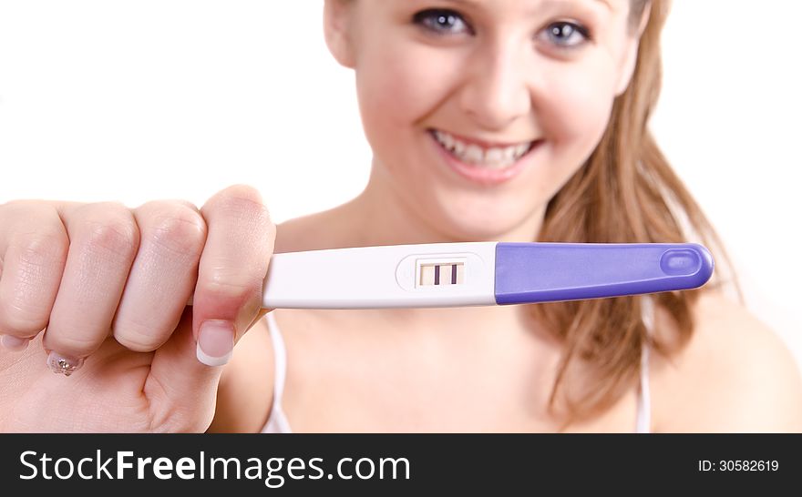 Cute girl is showing her positive pregnancy test.