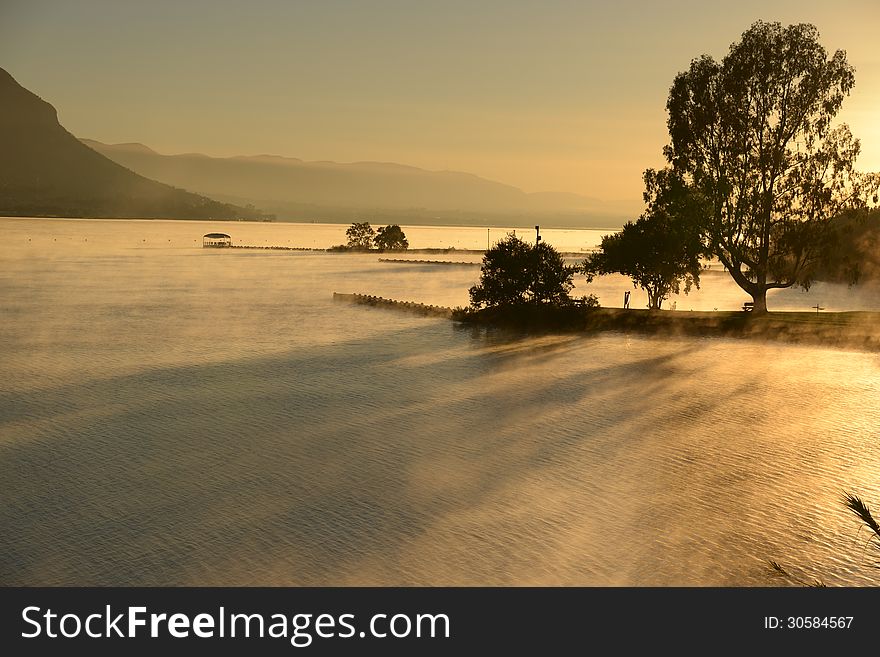 Early morning mist at Hartebeesport Dam Gauteng South Africa. Shot taken just after sun rise as mist is lifting