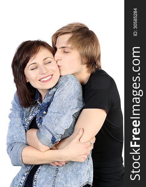 Young caucasian lovely couple kissing with closed eyes on white background