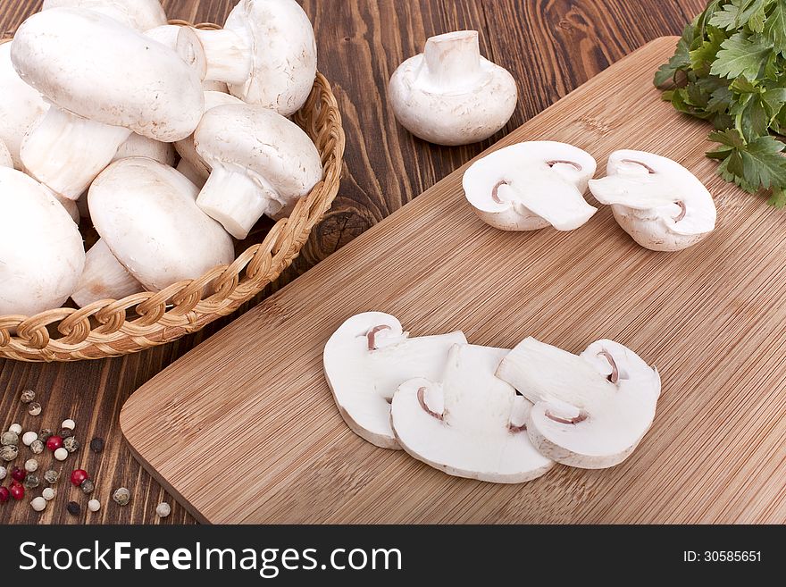 Champignons on a cutting board on a wooden background