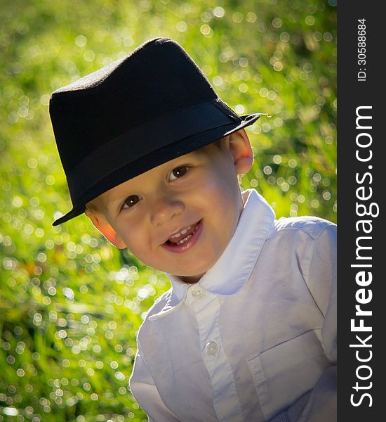 Young Smiling Boy In Black Hat