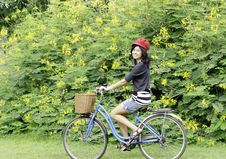 Happy Smiling Girl Riding A Bicycle In The Park Royalty Free Stock Photography