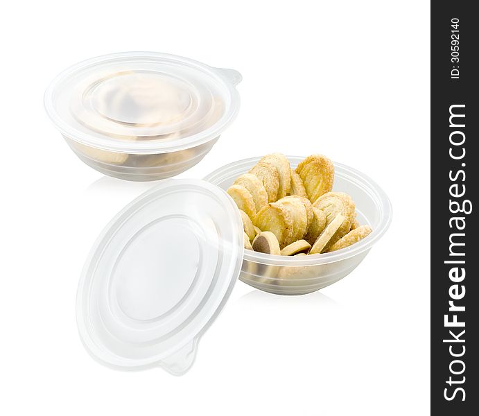Cookies and biscuits in the plastic bowl on white background. Cookies and biscuits in the plastic bowl on white background