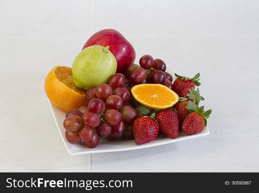 Fruits on dish display on the kitchen table