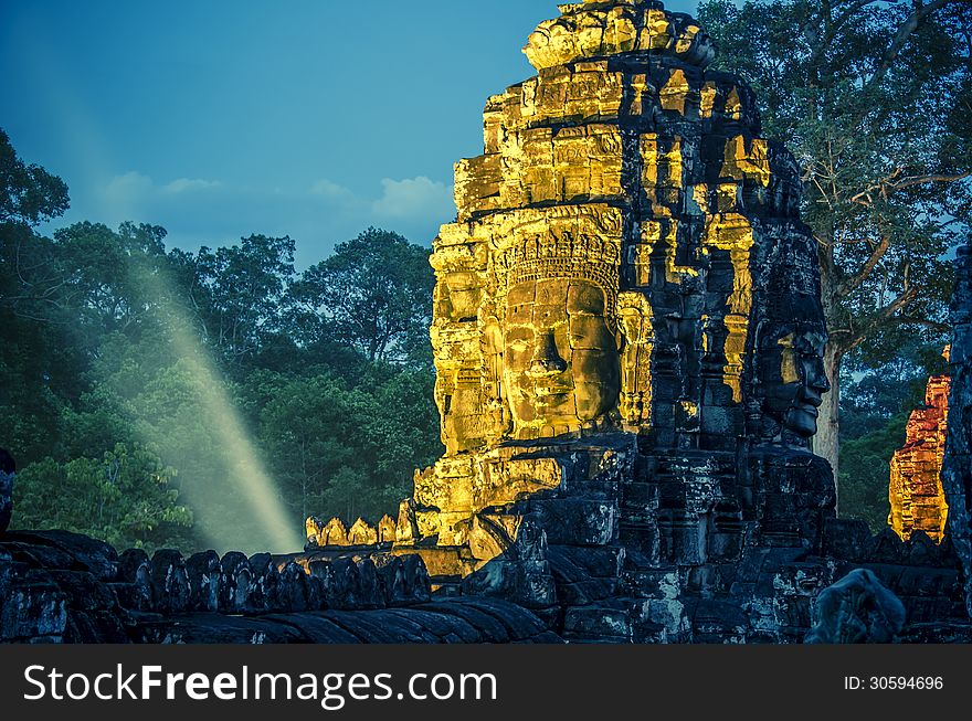 Golden stone face of Bayon temple. Golden stone face of Bayon temple