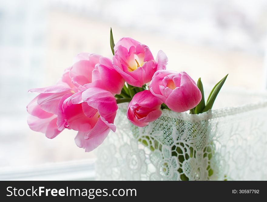 Still life with beautiful pink flowers in a lace decorative box closeup. Still life with beautiful pink flowers in a lace decorative box closeup