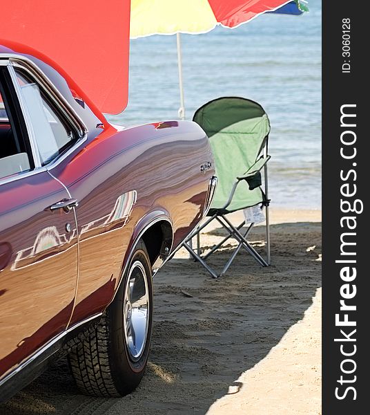 Beach chair, umbrella and classic car on the shore. Beach chair, umbrella and classic car on the shore