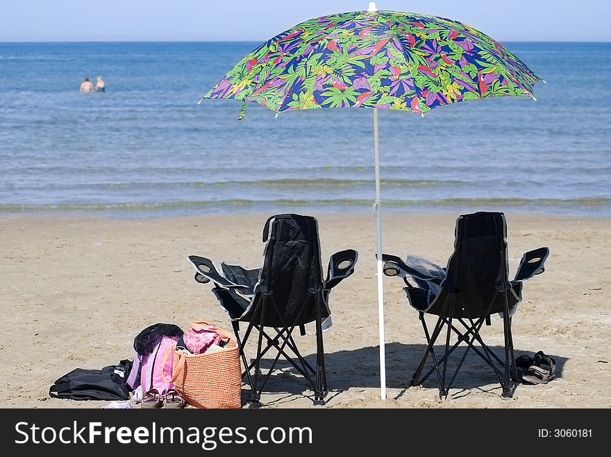 Chairs And Umbrella On Beach