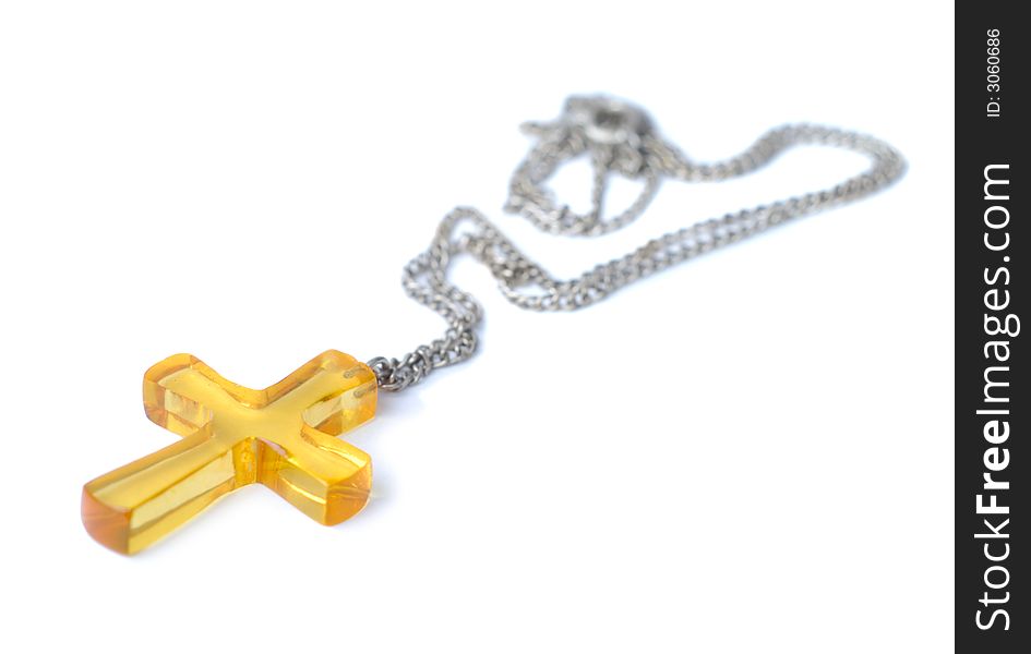 Amber cross with small chain isolated over white background