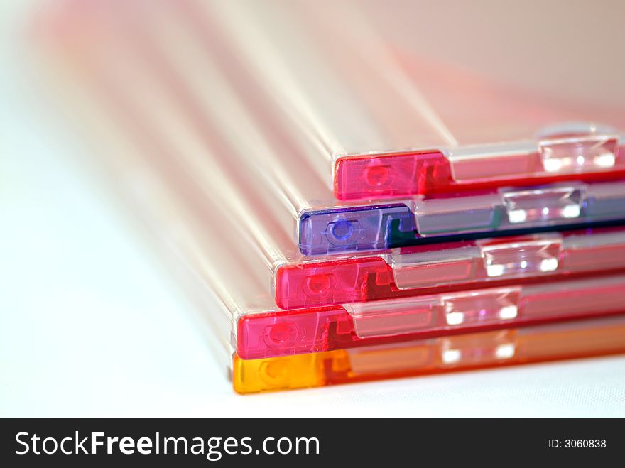 A stack of colored CD cases against a white background. A stack of colored CD cases against a white background.