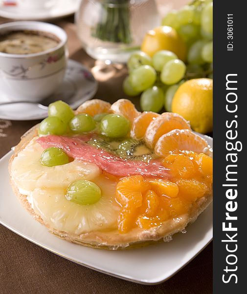 Delicious fresh fruit tarta with oranges, grapes and pineapple