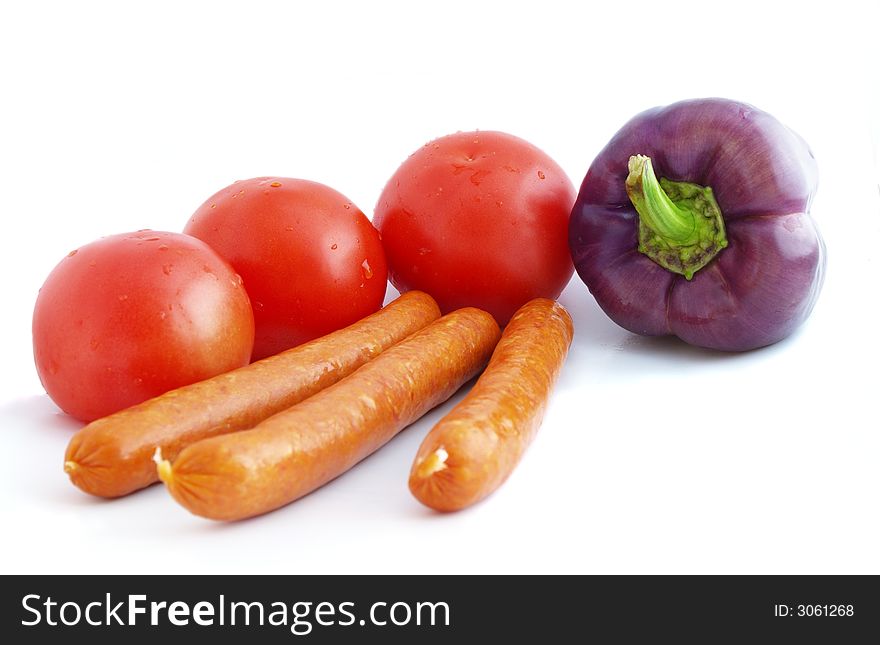 Sausages, tomatoes and violet pepper bell isolated on white background. Sausages, tomatoes and violet pepper bell isolated on white background