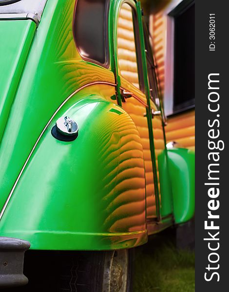 Old car with reflections of a wooden wall