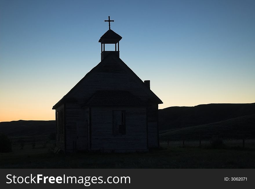 An old unused church located in the badlands of Alberta at sunset. An old unused church located in the badlands of Alberta at sunset.