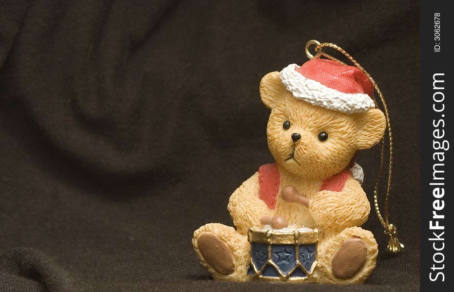 Small bear figure on christmas dressing over black background. Small bear figure on christmas dressing over black background