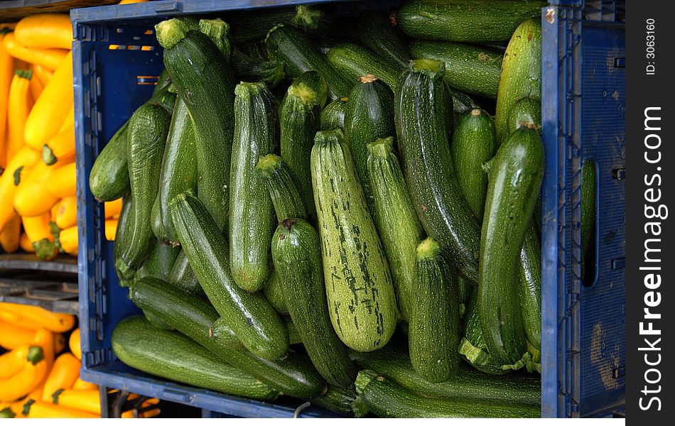 Green and yellow squash in bins at market. Green and yellow squash in bins at market