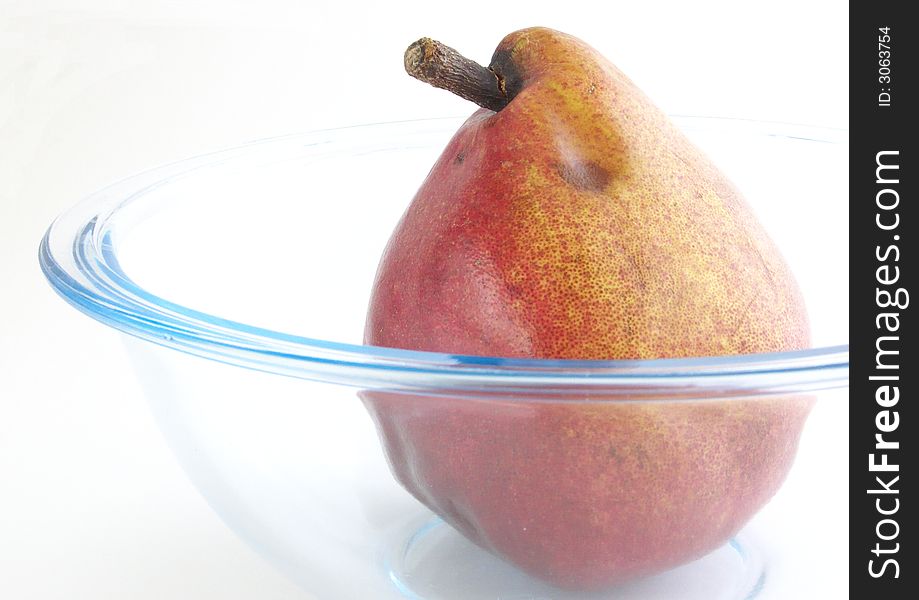 Pear rests in a glass vases. Isolated on a white background.