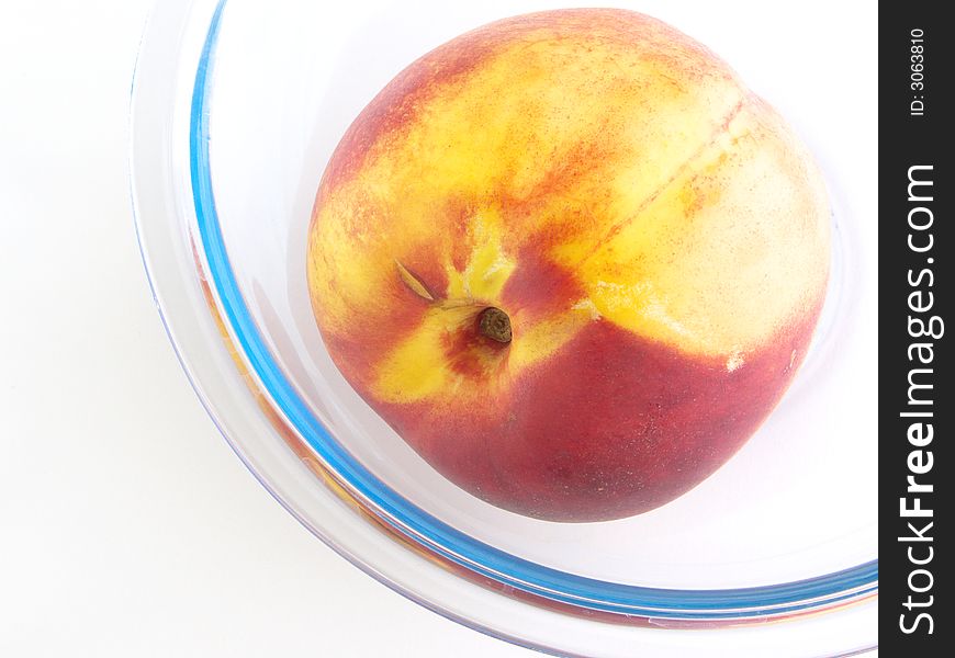 Peach rests in a glass vases. Isolated on a white background.