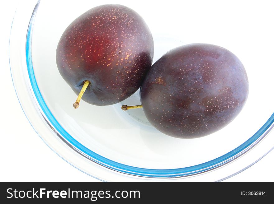 Two plums are in glass vases. Isolated on a white background.