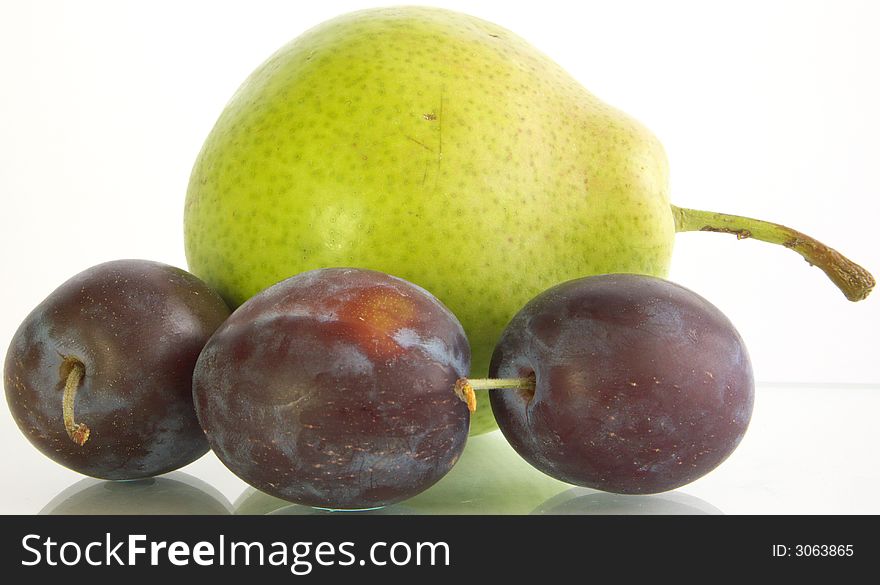 Three plum and pear on a white background. Was on a glass substrate.