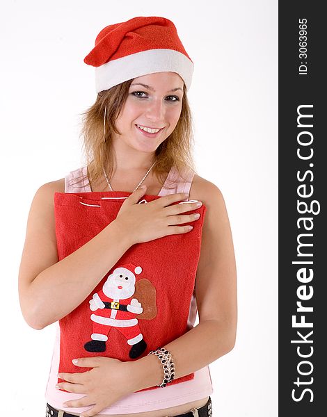 Girl wearing a santa hat and holding christmas bag. Girl wearing a santa hat and holding christmas bag