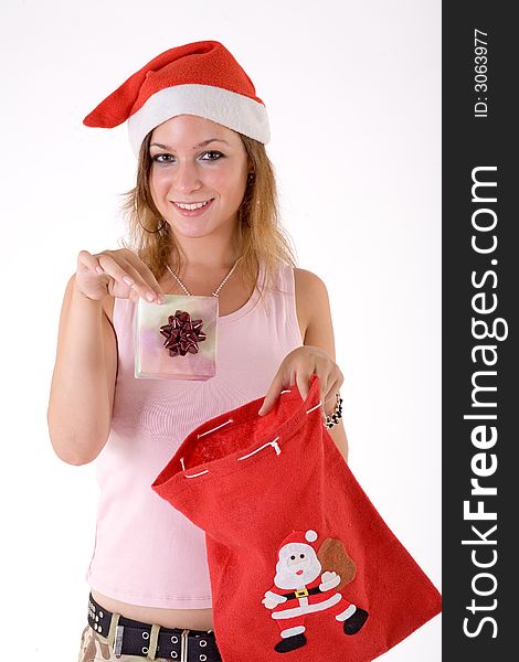 Girl wearing a santa hat and holding a gift box. Girl wearing a santa hat and holding a gift box