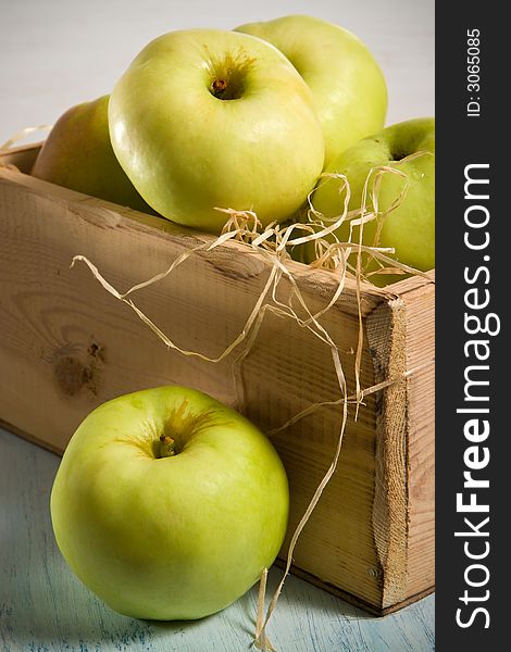 Green apples in the  wooden box. Green apples in the  wooden box