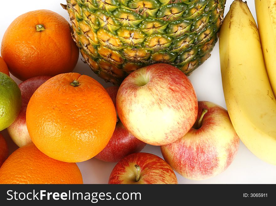 Fresh pineapple and fruits on white background