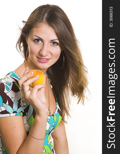 The young beautiful girl with a peach on a white background. The young beautiful girl with a peach on a white background