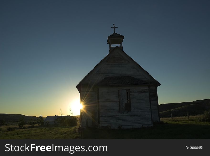 An old unused church located in the badlands of Alberta at sunset. An old unused church located in the badlands of Alberta at sunset