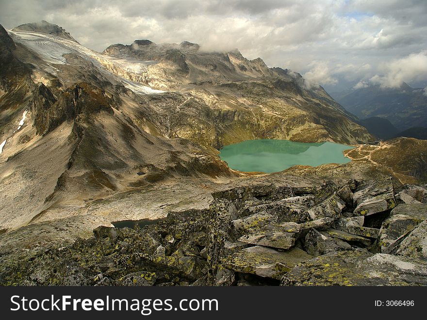 Blue lake in Austrian Alps among high mountains. Blue lake in Austrian Alps among high mountains.