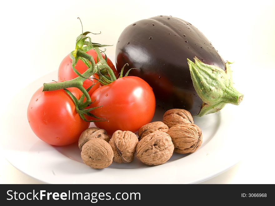 Fresh  eggplant,tomatoes,walnuts -isolated on white. Fresh  eggplant,tomatoes,walnuts -isolated on white.