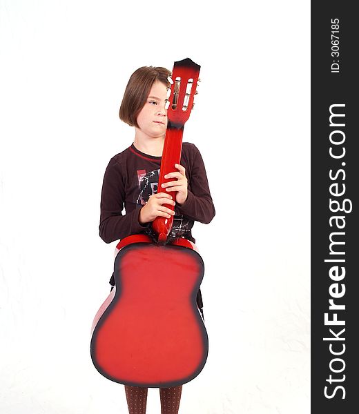 Brunette little girl and her red guitar